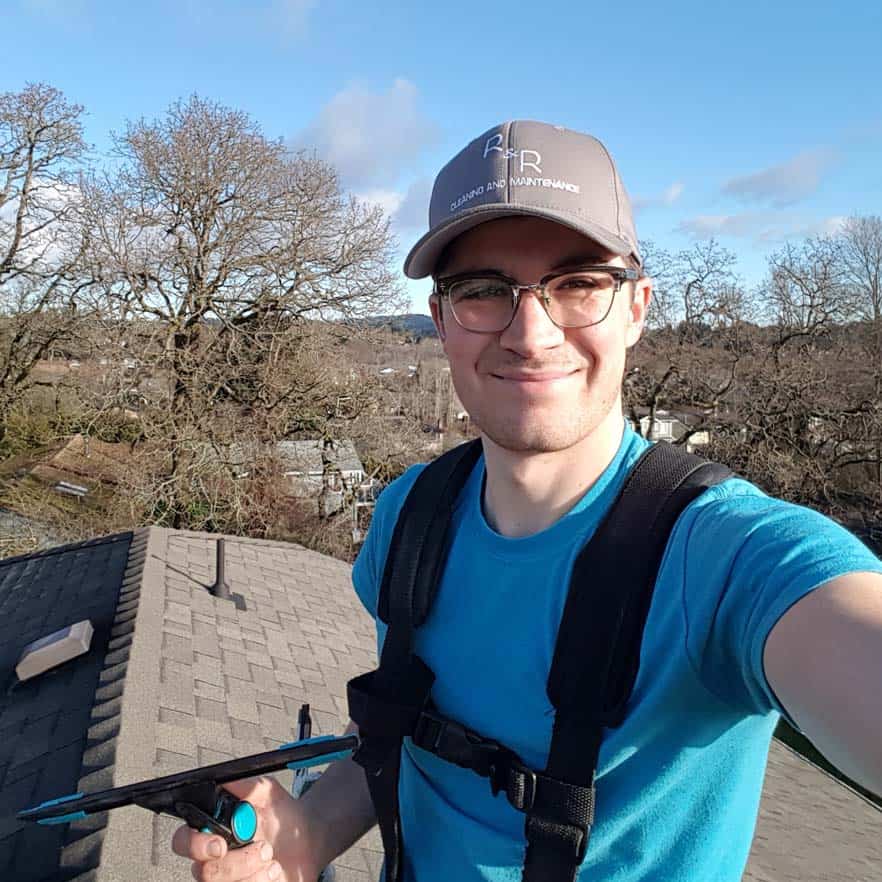 Ryland on a roof, with proper safety equipment for fall protection